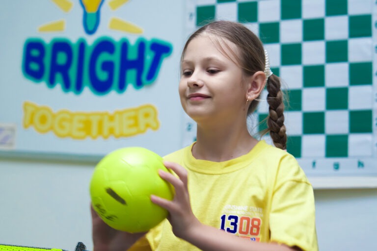 girl holding robot in afterschool