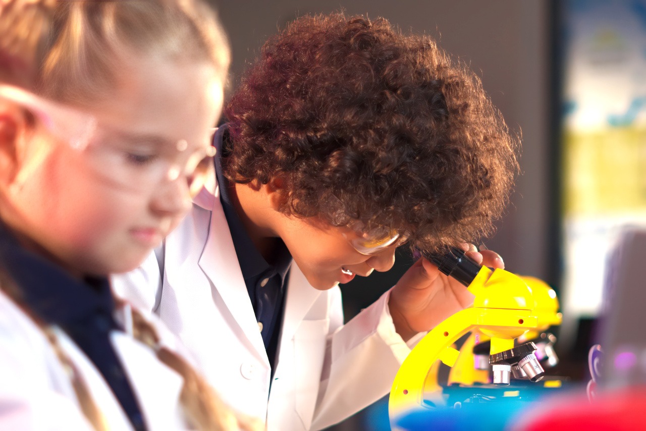 elementary school boy looking at microscope