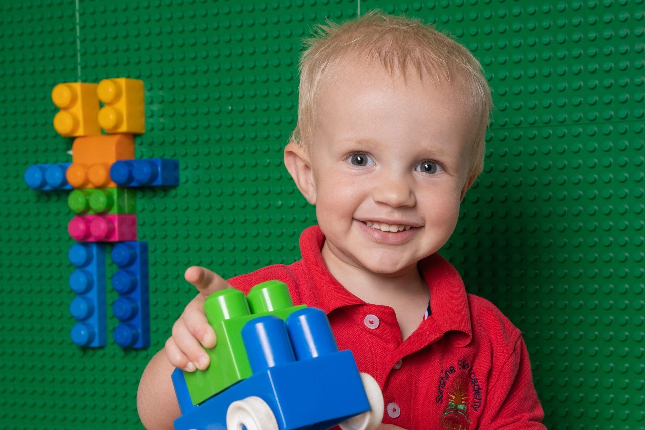 boy holding a to in preschool